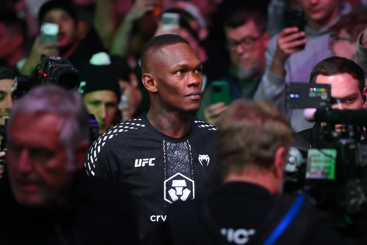 Mar 28, 2026; Seattle, Washington, USA; Israel Adesanya (red gloves) enters the arena before the fight against Joe Pyfer (blue gloves) during UFC Fight Night at Climate Pledge Arena. Mandatory Credit: Steven Bisig-Imagn Images