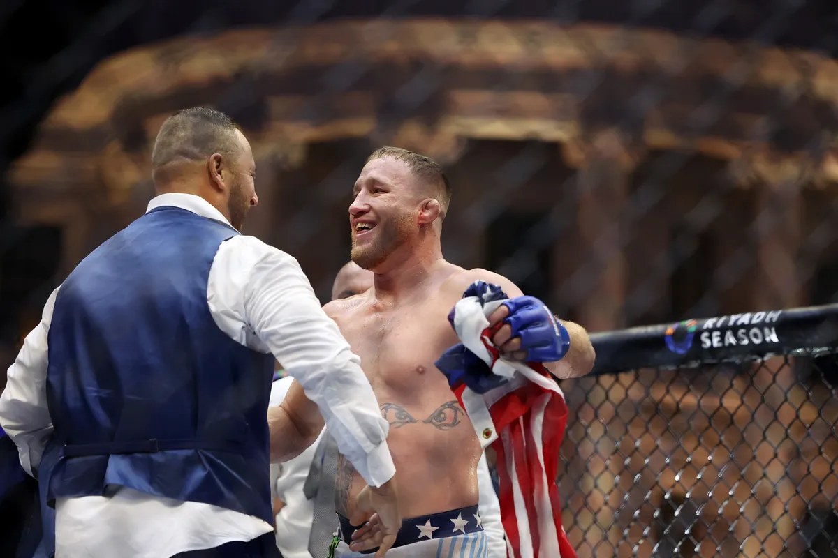 Jun 14, 2026; Washington, D.C., USA; Justin Gaethje (blue gloves) celebrates with his team after winning the UFC Freedom 250 fight against Ilia Topuria (not pictured) at the White House South Lawn. Mandatory Credit: Amber Searls-Imagn Images