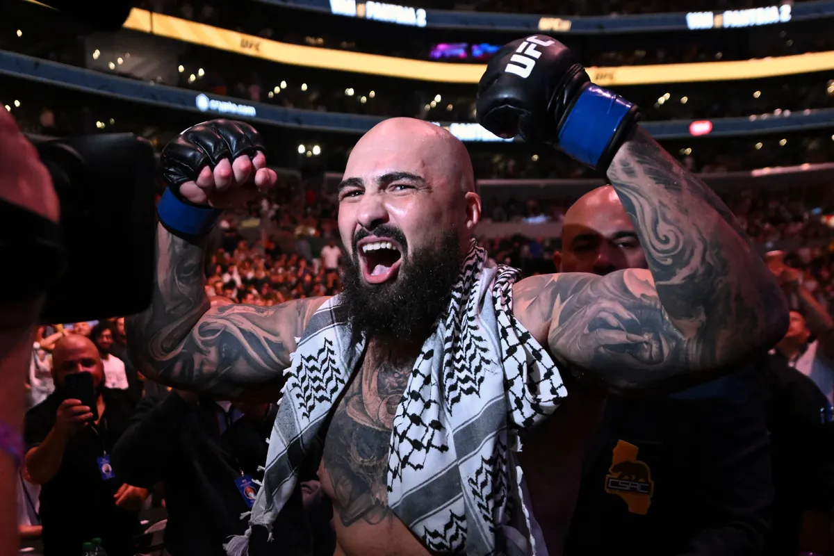 Sep 19, 2026; Los Angeles, California, USA; Sean Sharaf (blue gloves) reacts after defeating Gable Steveson (not pictured) during UFC 331 at Crypto.com Arena. Mandatory Credit: Griffin Hooper-Imagn Images
