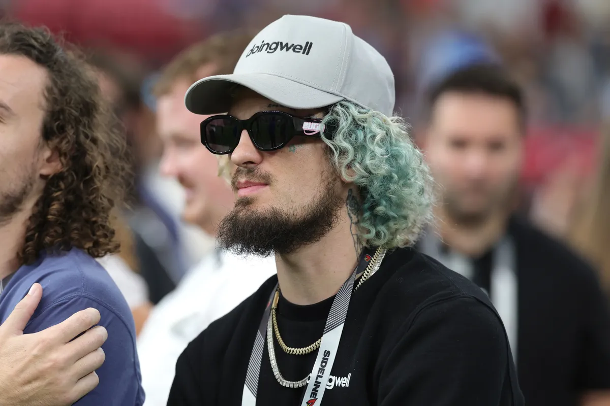 Oct 11, 2026; Glendale, Arizona, USA; UFC fighter Sean O'Malley watches warmups before the game between Detroit Lions and Arizona Cardinals at State Farm Stadium. Mandatory Credit: Mark J. Rebilas-Imagn Images